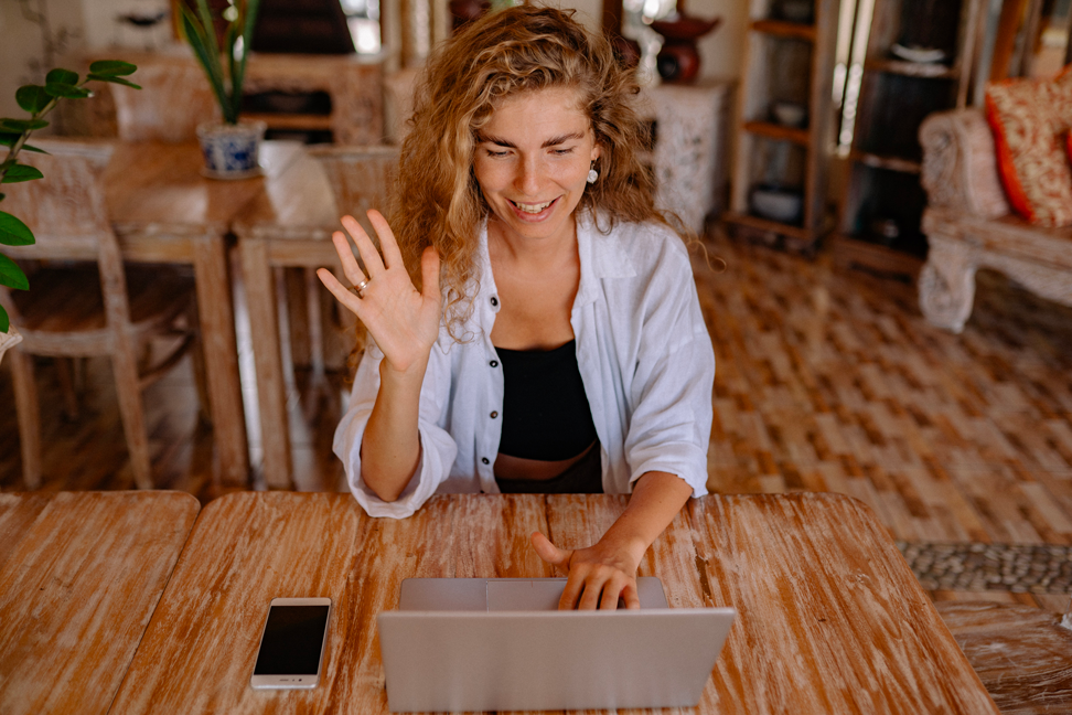 A Woman Is Sitting in Front of Her Laptop and Waving to Someone Through the Camera. - Eventdrive Blog Article