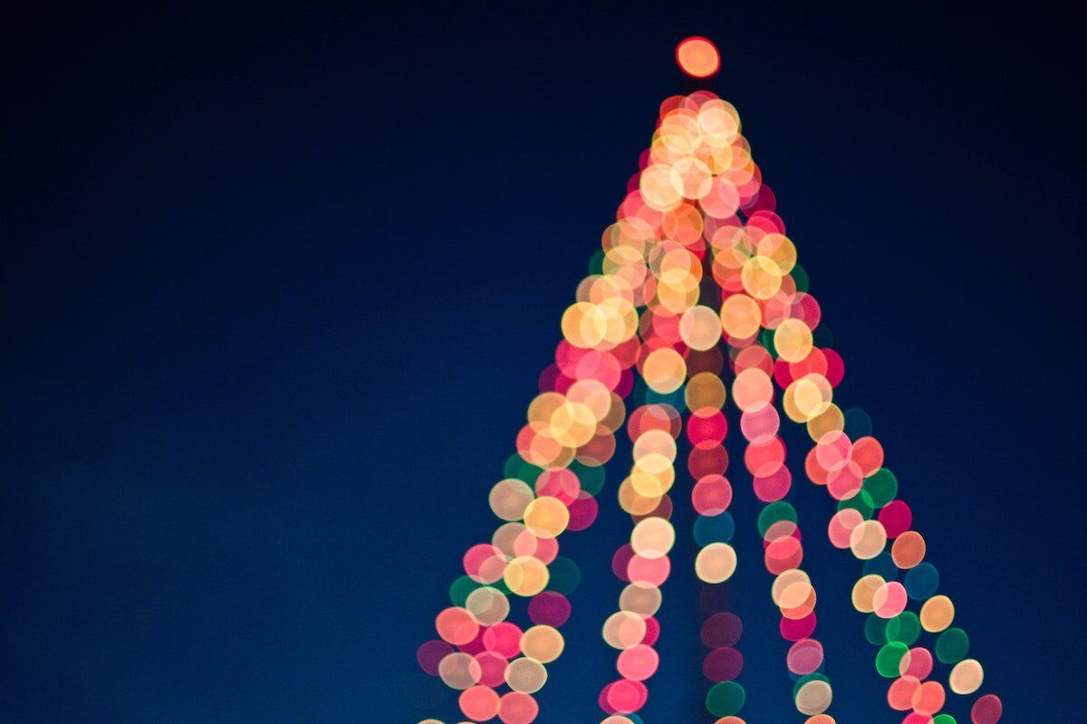 A Christmas tree is lit up. - Eventdrive Blog Article