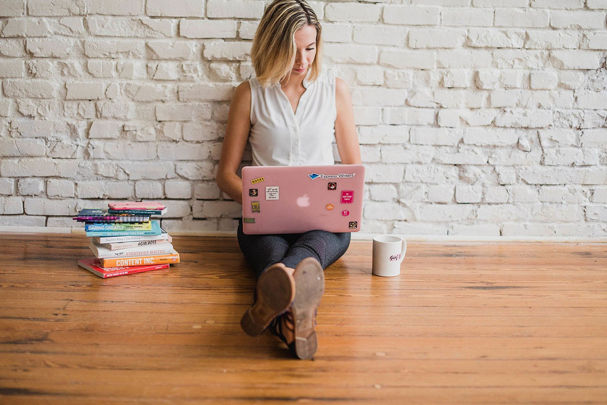 A Woman Is Sitting on the Ground and Looking at Her Laptop. - Eventdrive Blog Article