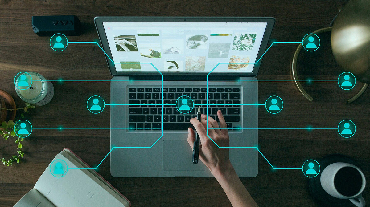 A Person Is Using a Laptop, With a Digital Interface Displaying Icons of Interconnected People, Symbolizing a Network or Online Collaboration. - Eventdrive Blog Article