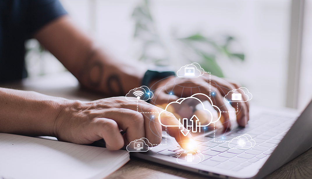 Two Hands Typing on a Laptop Keyboard With Superimposed Cloud Icons, Symbolizing Connections and Data Transfers to the Cloud. - Eventdrive Blog Article