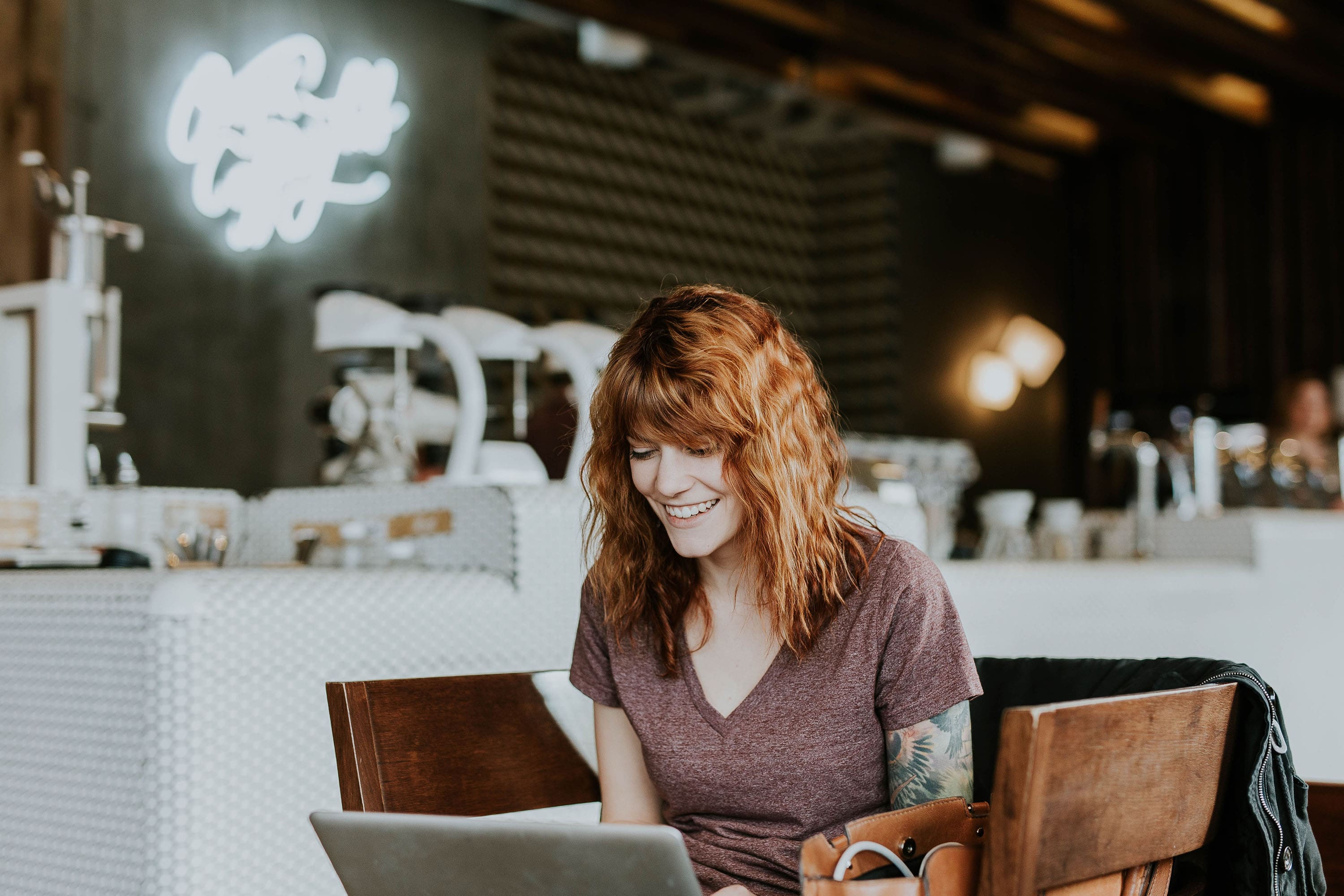 A Woman Smiles in Front of Her Computer. - Eventdrive Blog Article