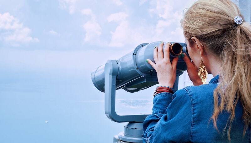 A Woman Is Looking Through Binoculars. - Eventdrive Blog Article